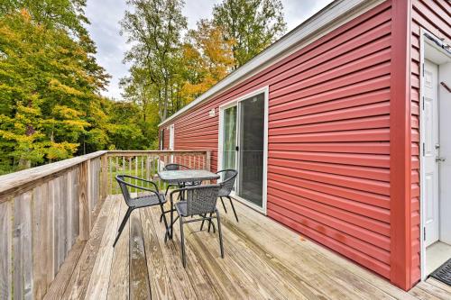 a patio with two chairs and a table on a wooden deck at Pet-Friendly Cassopolis Escape with Lake Access in Cassopolis