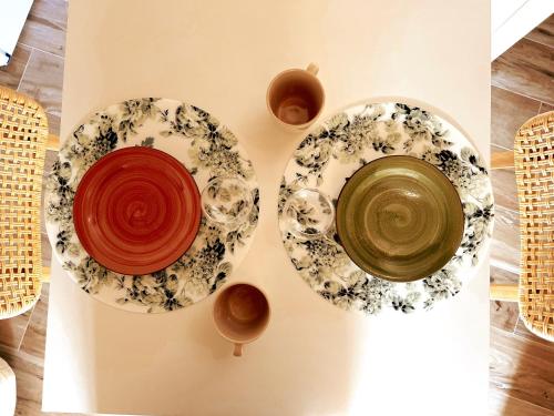 three plates and bowls sitting on a table at San Ranieri Tiny Tower in Pisa