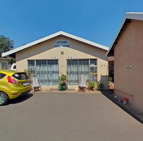 a yellow car parked in front of a building at JoThams Bed & Breakfast or Self-catering in Durban