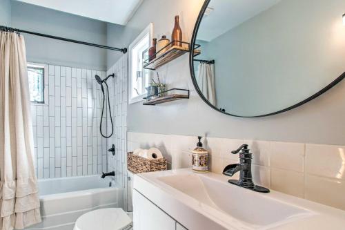 a bathroom with a sink and a mirror at Beautifully Restored Farmhouse in Marshall! in Marshall