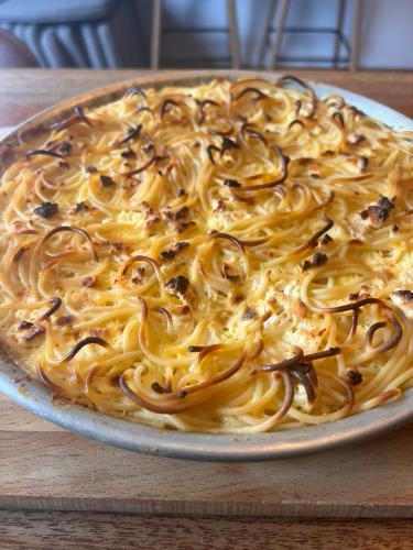 a pasta dish on a plate on a table at Condesa in Tirana