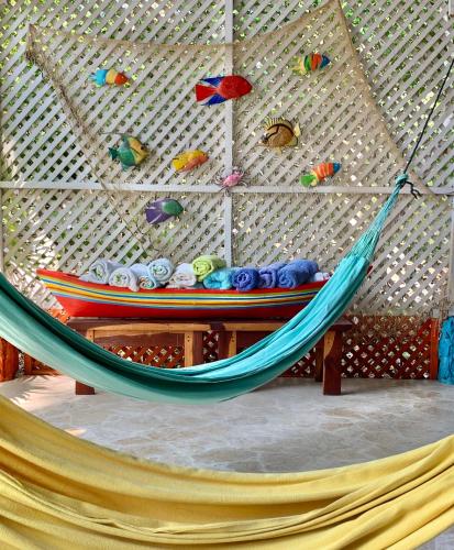 a hammock in a room with a wall at Casita Caribe en reserva natural, playa privada, kayaks, wifi, aire acondicionado in San Onofre