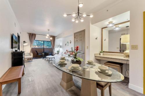 a dining room and living room with a table and a mirror at Designer Corner Suite 3BR/2BA -Disney & Universal in Orlando