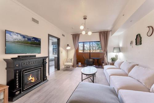 a living room with a couch and a fireplace at Designer Corner Suite 3BR/2BA -Disney & Universal in Orlando