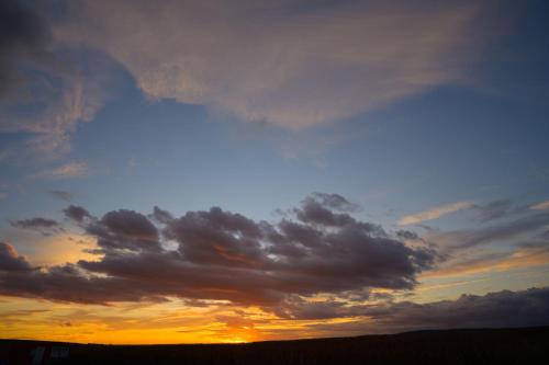 a cloudy sky at sunset in a field at Merlin's Camp in Znojmo