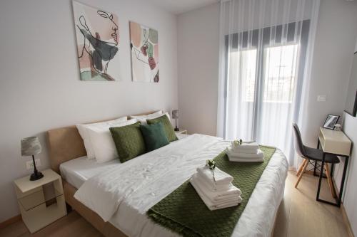 a bedroom with a bed with two towels on it at LINA - PG, Moraca River Apartment in Podgorica