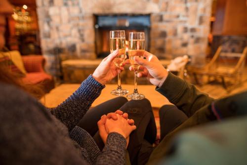 a group of people holding up glasses of wine at High Peaks Resort in Lake Placid