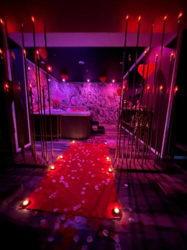 a stage with red lights and a red carpet at Why Not Jacuzzi in Arles