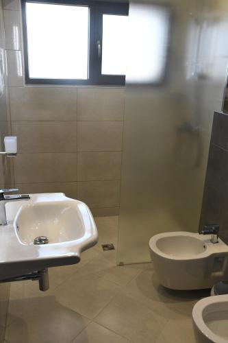 a bathroom with a sink and a toilet at Къща за гости Авена in Banya