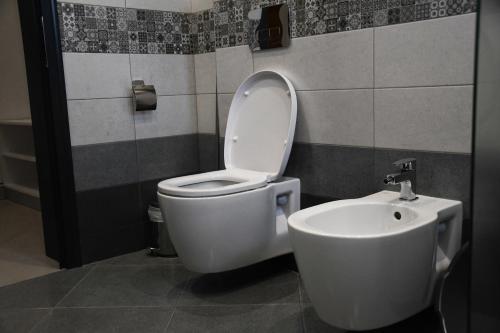 a bathroom with a toilet and a sink at Къща за гости Авена in Banya