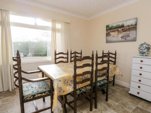 a dining room with a table and chairs and a window at Silverdale Mount in Grange Over Sands