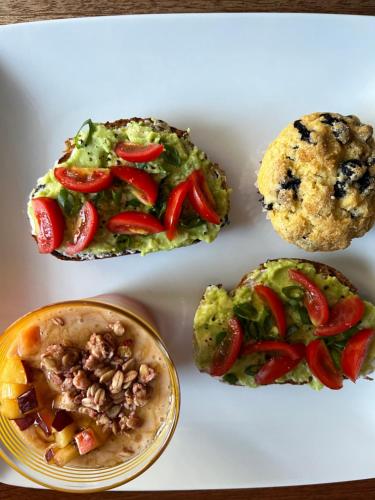 a plate of food with muffins and vegetables on it at Condesa in Tirana