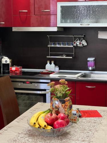 a bowl of fruit on a table in a kitchen at Къща за гости Шарон in Petrich