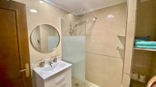 a bathroom with a shower and a sink and a mirror at Beautiful apartment near LaMata Beach with PANORAMA SEA view!!! in Torrevieja