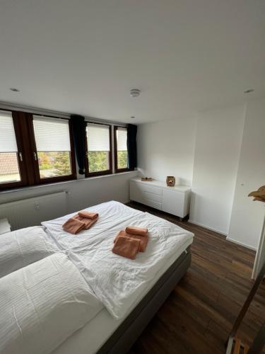 a bedroom with a bed with two towels on it at Appartementhaus Silberborn in Bad Harzburg