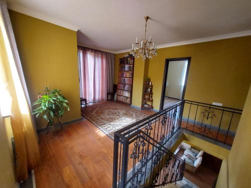 a living room with a staircase and yellow walls at Гостевой дом в центре Тбилиси in Tbilisi City