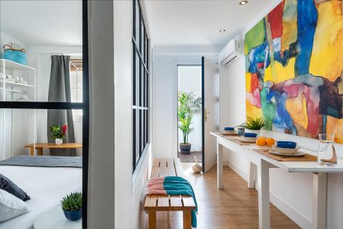 a room with a large colorful painting on the wall at Apartamento Aljarafe in Valencina de la Concepción