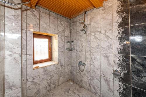 a bathroom with a shower and a window at Secret Haven Villa in Fethiye