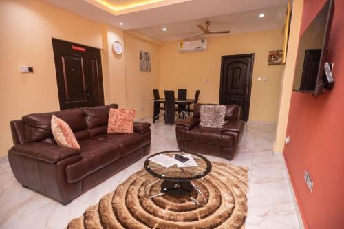 a living room with a couch and a table at Stunning 2-Bedroom Furnished Apartment in Accra in Accra