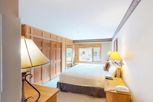 a bedroom with a bed and a desk with a telephone at Shoshone 1930 in Big Sky