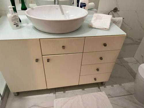 a bathroom with a bowl sink on a counter at Invicta House Gold in Porto