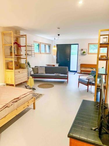 a living room with a bed and a couch at See-Appartement Wörthsee in Wörthsee