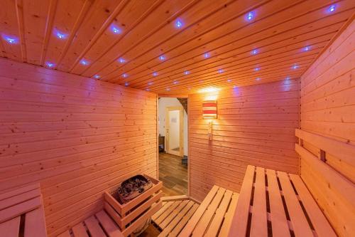a wooden room with a sauna with a fire pit at Chalupa Lilien pod Medvědí skálou Jeseníky in Jindřichov