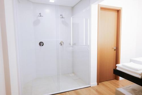 a bathroom with a shower with a glass door at Hotel do Gringo in Erval Velho