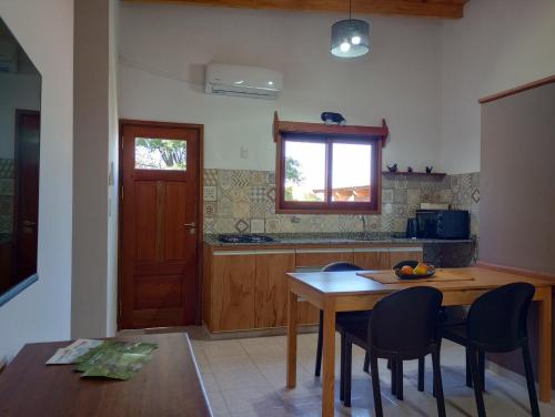 a kitchen with a table and chairs and a window at Eldorado Apart in Eldorado