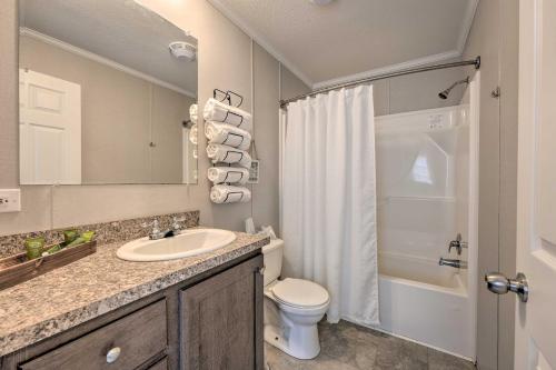 a bathroom with a sink and a toilet and a shower at Cassopolis Cabin On-Site Boating and Fishing! in Cassopolis