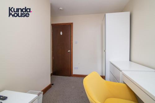 an office with a yellow chair in a room at Kunda House Dawlish in Birmingham