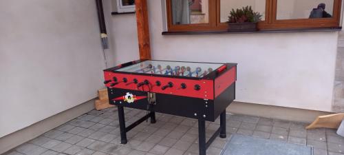 a red and black dresser with figurines in it at Ubytování na statku in Holubov