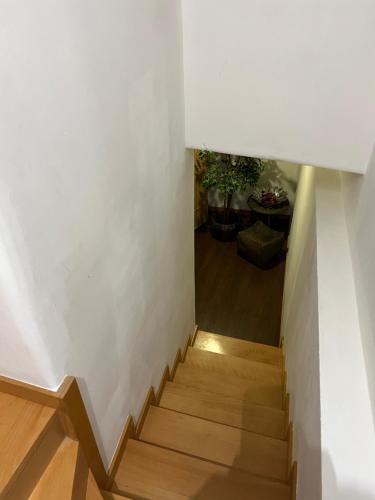 a staircase with white walls and wooden floors at Invicta House Gold in Porto