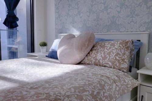 a pillow sitting on top of a bed at Cozy 1BR Apartment in the heart of Canberra in Canberra