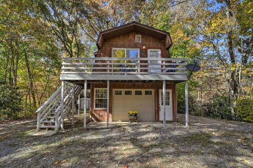 a tiny house with a porch and a deck at Sky Loft Bryson Studio 1 Mi From Fontana Lake! in Bryson City