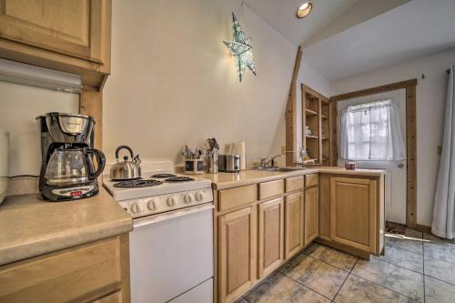 a kitchen with a white stove top oven next to a sink at Sky Loft Bryson Studio 1 Mi From Fontana Lake! in Bryson City