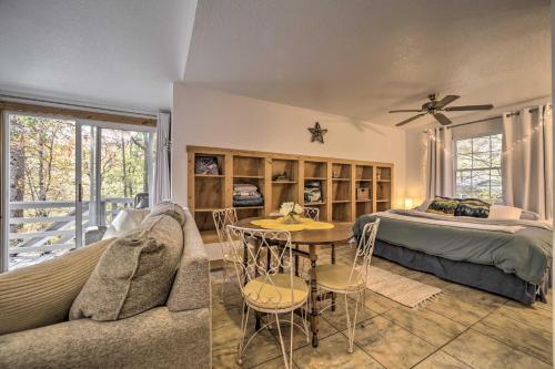 a bedroom with a bed and a table and a couch at Sky Loft Bryson Studio 1 Mi From Fontana Lake! in Bryson City