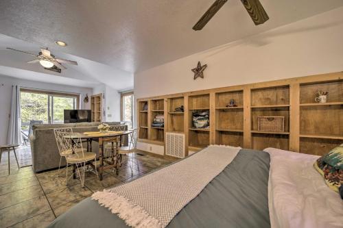a bedroom with a bed and a table and a kitchen at Sky Loft Bryson Studio 1 Mi From Fontana Lake! in Bryson City