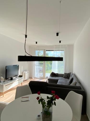 a living room with a couch and a table at Lela lakeside apartman a vizek szerelmeseinek in Balatonlelle