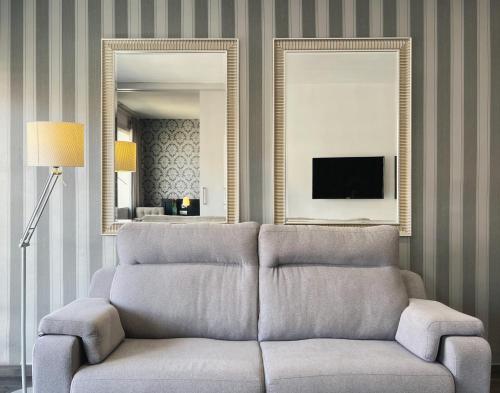 a living room with a couch and a mirror at Stay U-nique Apartments Beltrán i Rózpide in Barcelona