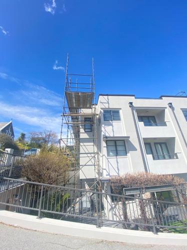 a building with scaffolding on the side of it at The Glebe Apartments in Queenstown