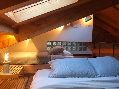 two beds in a room with a roof at Quintinha da Oliveira in Marco de Canavezes