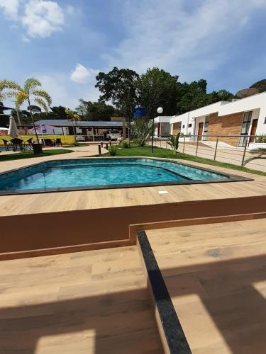 a swimming pool in a courtyard with a building at Pousada Flor de Alter in Alter do Chao