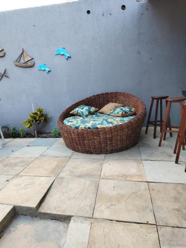 a wicker dog bed sitting on a patio at Pousada paraiso das dunas in Cumbuco