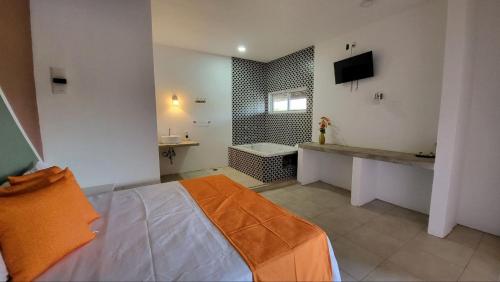 Hotel Punta Palmeras في غير متوفر: حمام به سرير وحوض استحمام ومغسلة