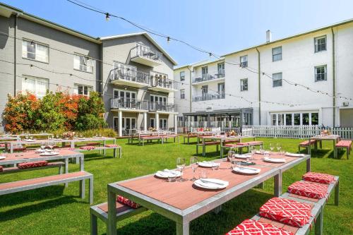 a patio with tables and chairs in front of a building at Mantra Lorne in Lorne