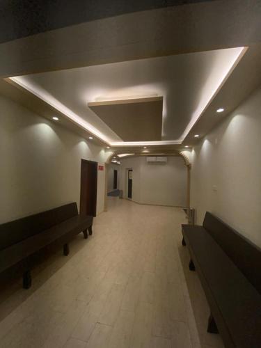 a room with two benches and a room with a room with a unintention at فندق ادوماتو ADOMATo HOTEl in Dawmat al Jandal