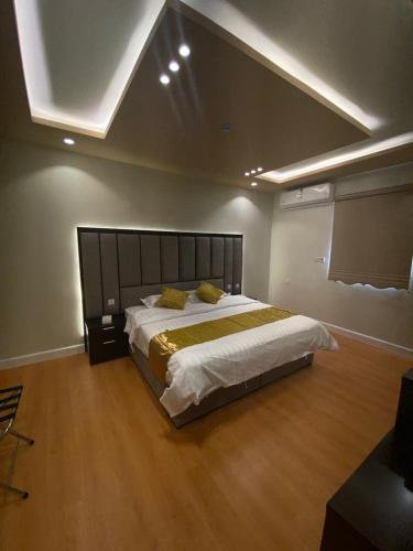 a bedroom with a large bed in a room at فندق ادوماتو ADOMATo HOTEl in Dawmat al Jandal