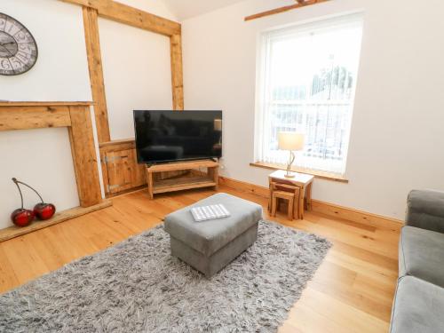 a living room with a couch and a television at Flat Above 27 in Bishop Auckland