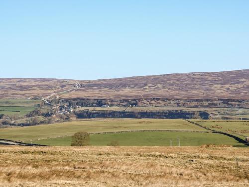 a view of a field with hills in the background at Flat Above 27 in Bishop Auckland